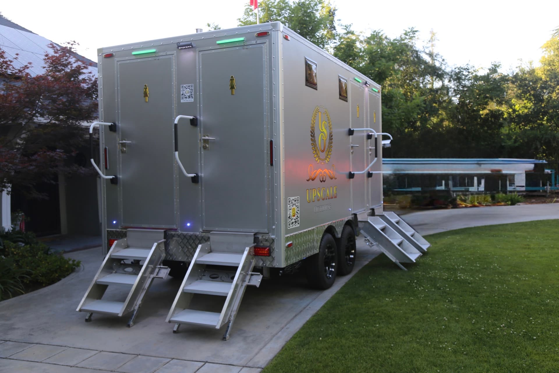 Luxury restroom trailer at a professional venue on manicured lawn
